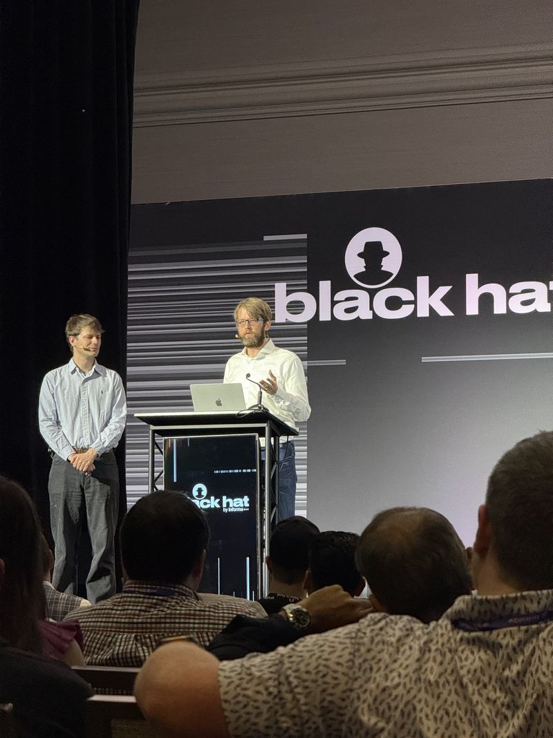 Photo: The two OpenAI speakers standing at the front of the Black Hat session room