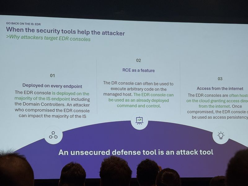 Slide: Why attackers target EDR consoles — deployed on every endpoint including domain controllers, RCE as a feature, and internet-facing cloud hosting — under the line an unsecured defense tool is an attack tool